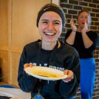 Student showing off pancake during pancake breakfast.